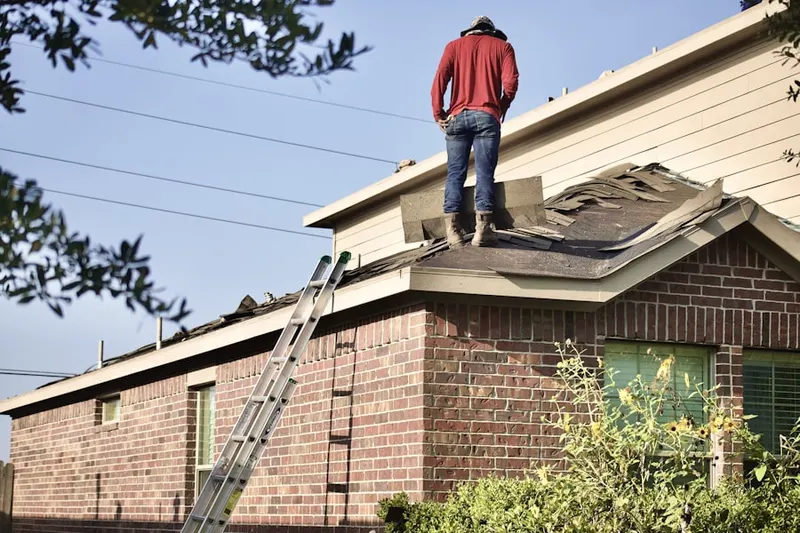 Professional roofer working on a residential roof in Old Myrtle